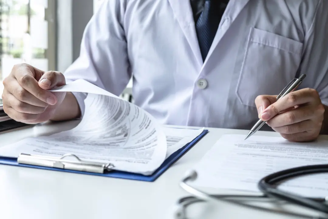 Physician using AI-assisted clinical documentation during a patient visit